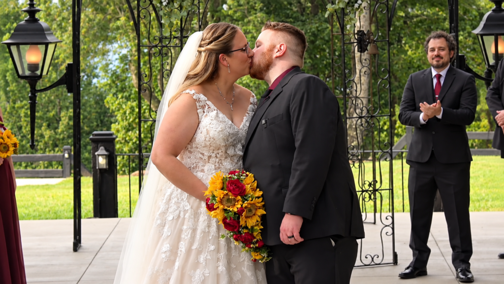 Ashley and Matthew share their first kiss during their Virginia wedding ceremony