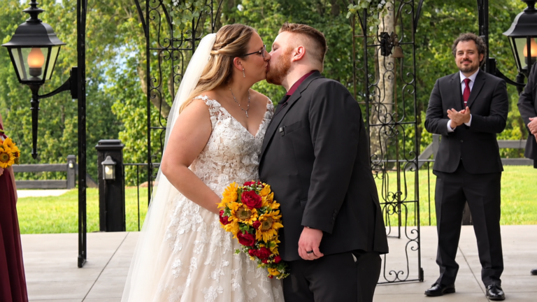 Ashley and Matthew share their first kiss during their Virginia wedding ceremony