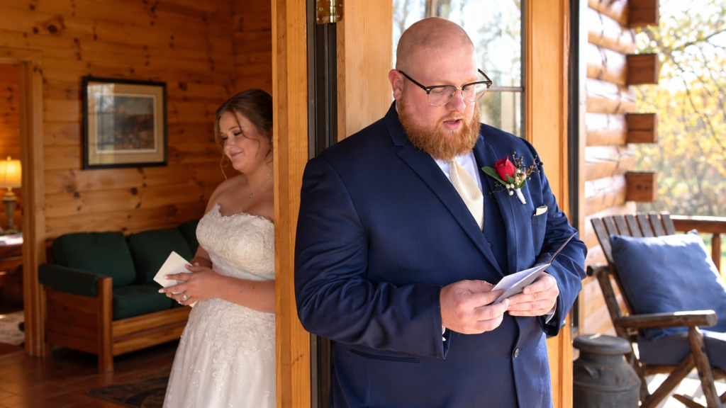 Bride and groom sharing private vows during a first touch outside a rustic cabin in Roanoke, Virginia