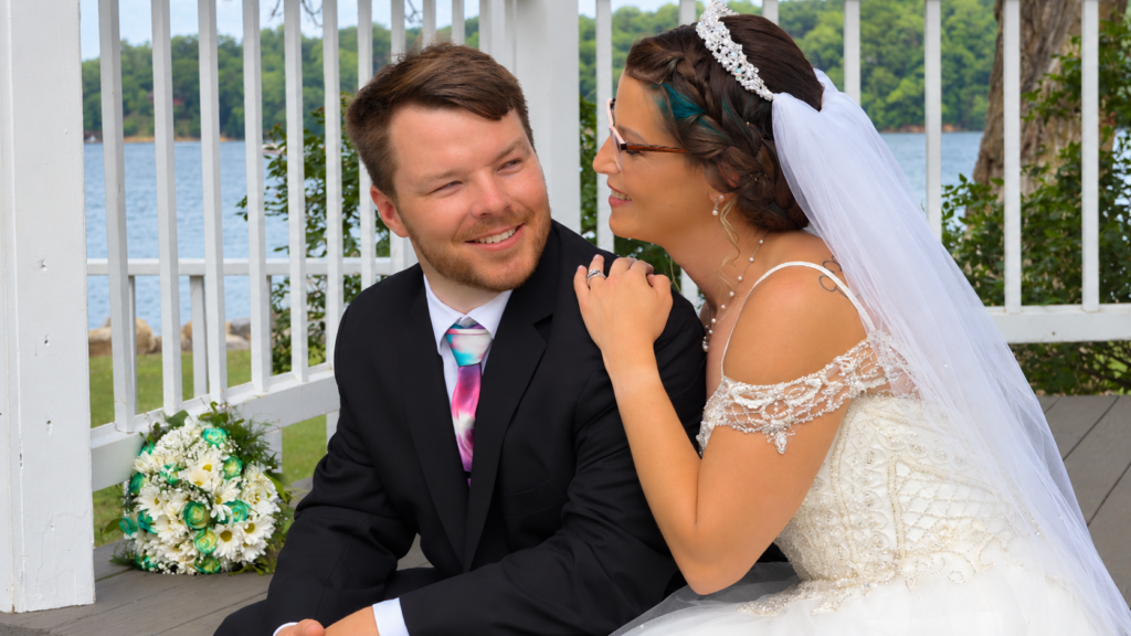 Bride and groom sharing a quiet moment at a lakeside gazebo in Virginia