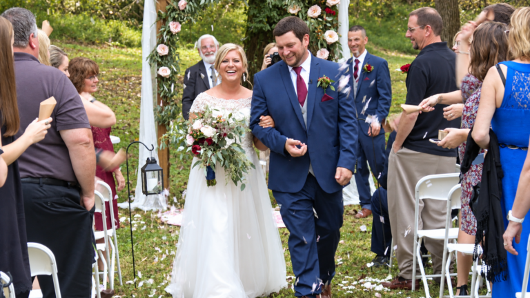 Tara and Billy walking down the aisle after their wedding ceremony at Early Inn at the Grove in Rocky Mount, Virginia